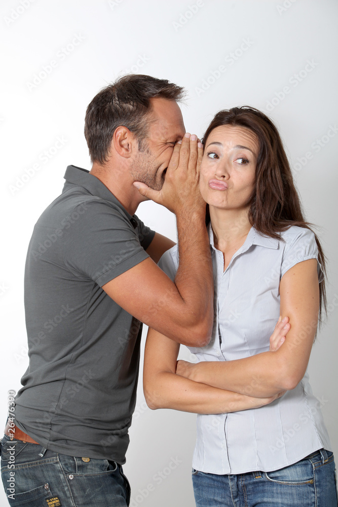 Man whispering to his girlfriend ear Man whispering to his girlfriend ear