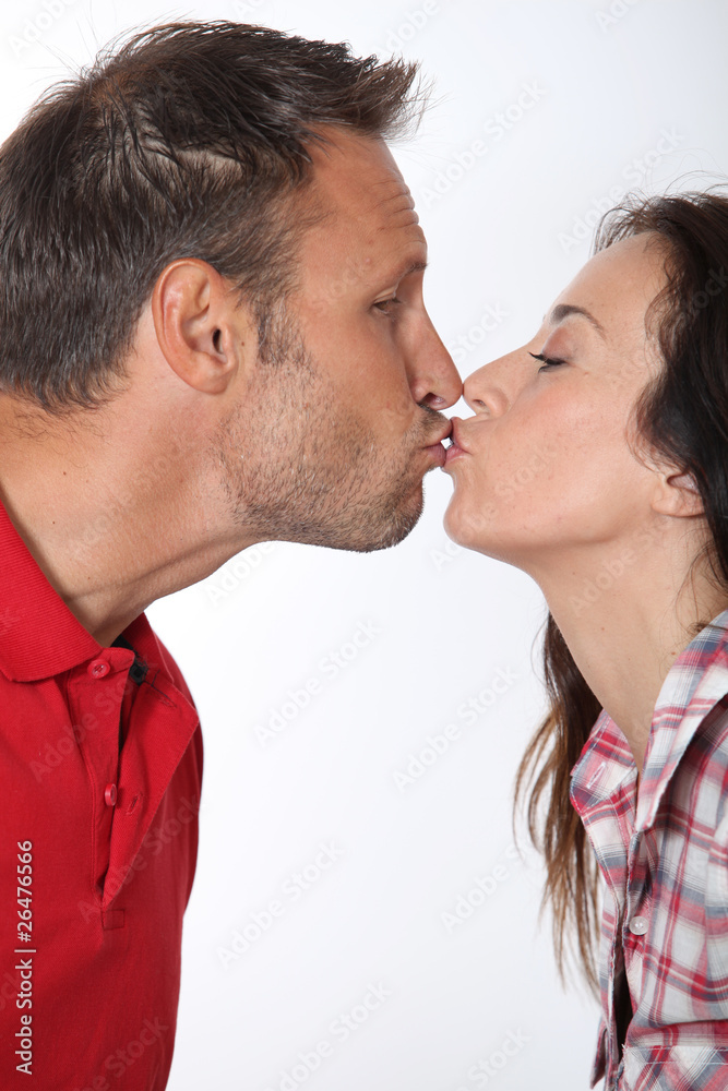 Naklejka premium Closeup of in loved couple kissing on white background