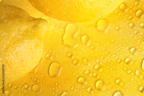 Water drops on yellow background and lemons