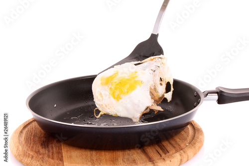 Fried egg in a frying pan isolated on a white background photo