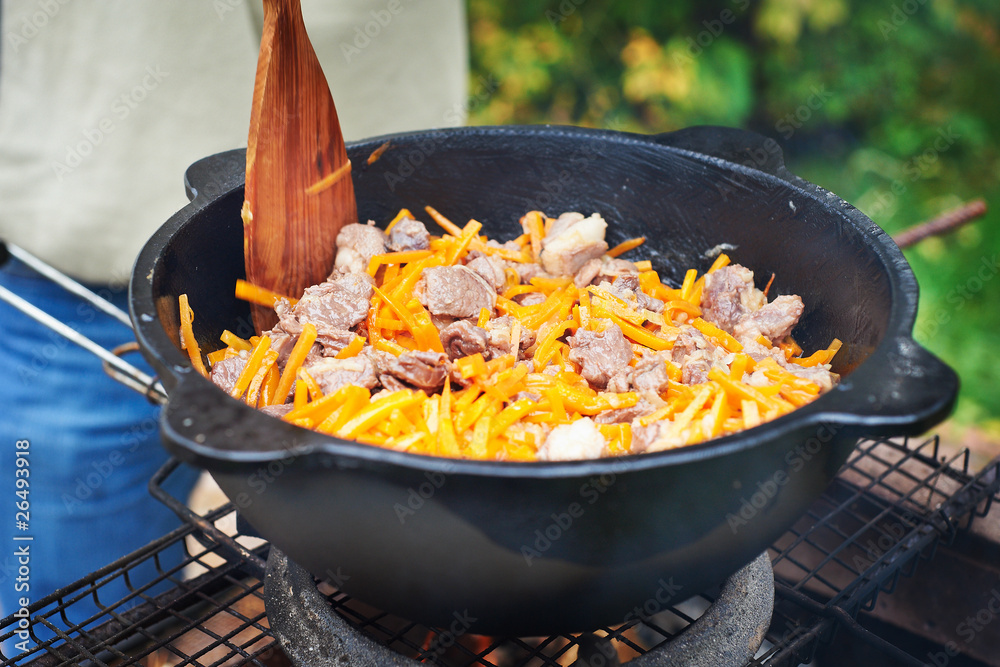 Sheep meat fried with onions and carrots in oil Sheep meat fried with onions and carrots in oil