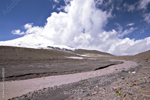 Glacier river against the peak Elbrus (5642m) in clouds