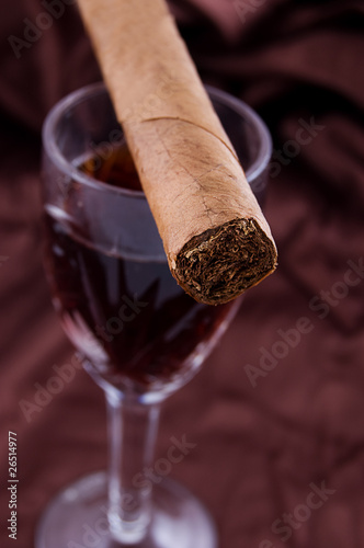 Cigar on the glass with alcohol