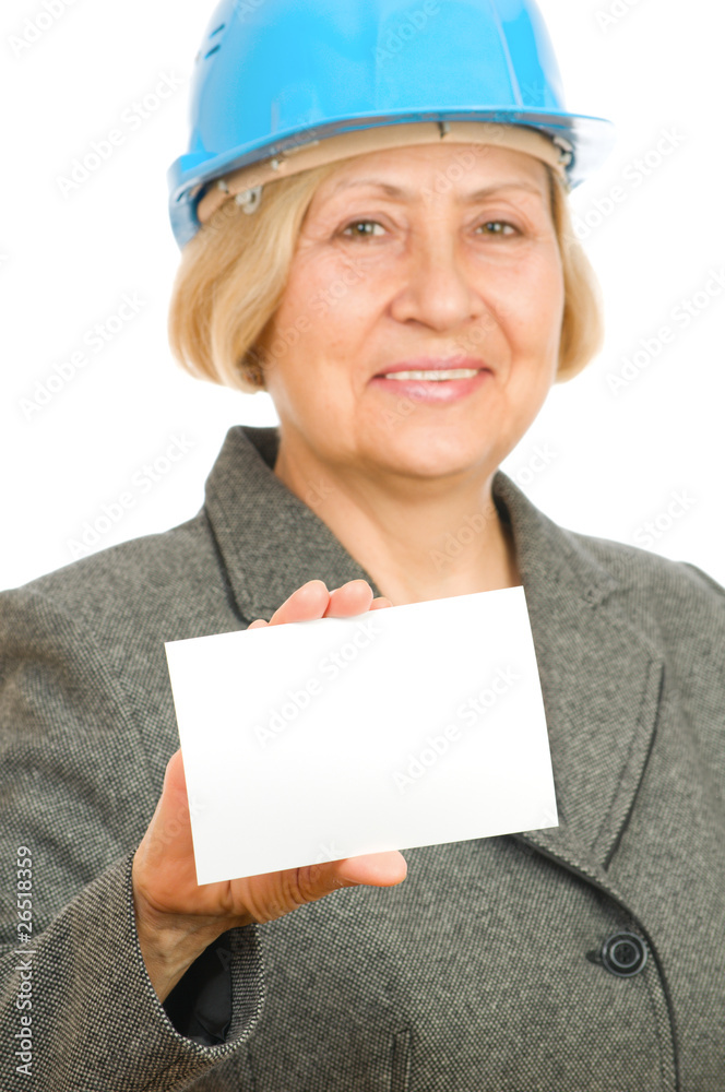 Senior woman with blue hard hat holding blank sigh