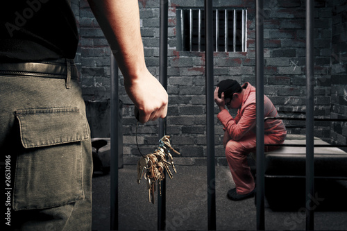 Canvas Print prison guard with keys outside dark prison cell