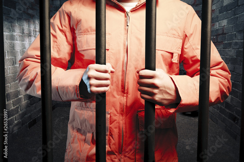 inmate inside dark prison cell at night photo