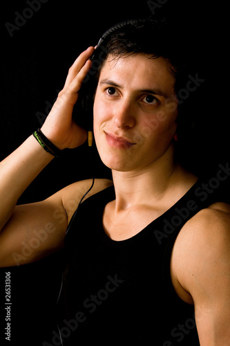 Young Man listening to music with headphones, on black backgroun © cristovao31