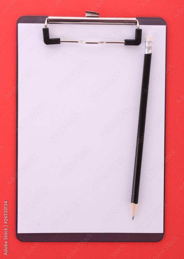 Clipboard and pencil on red background Clipboard and pencil on red background