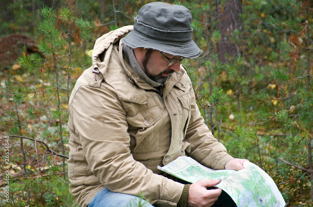 Hiker with map in forest
