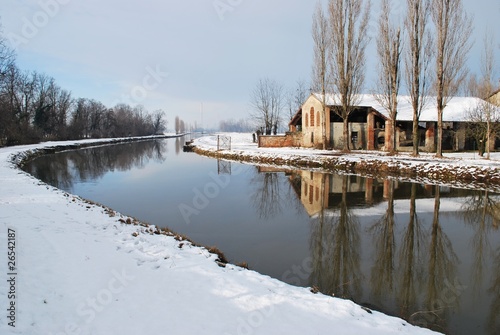 Country house on the river in winter, Po valley, Italy