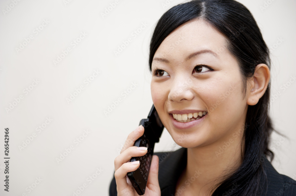 portrait of japanese business woman spearking on mobile phone portrait of japanese business woman spearking on mobile phone
