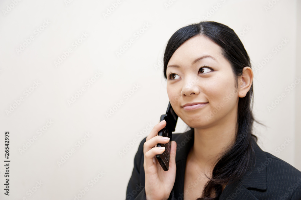 portrait of japanese business woman spearking on mobile phone portrait of japanese business woman spearking on mobile phone