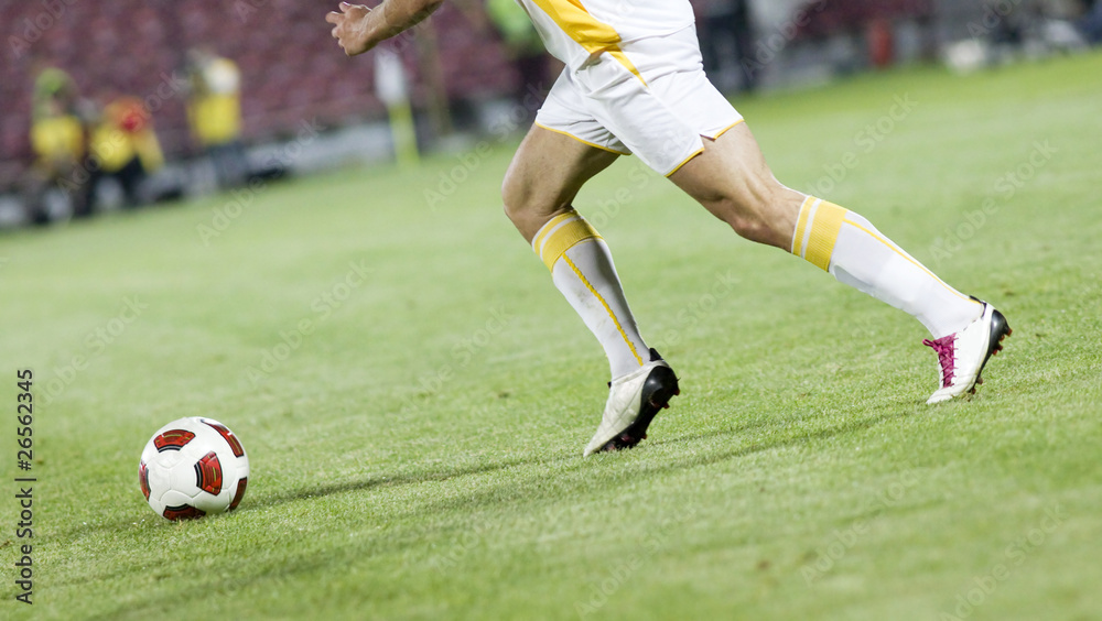 Soccer player running after the ball