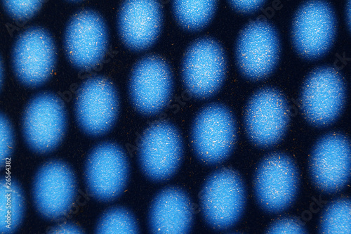 Abstract image of sun spots and shadows on blue surface