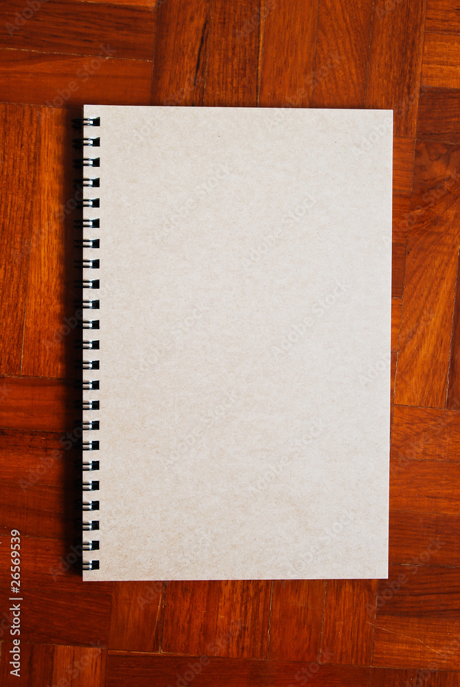 Brown notebook on the parquet background Brown notebook on the parquet background
