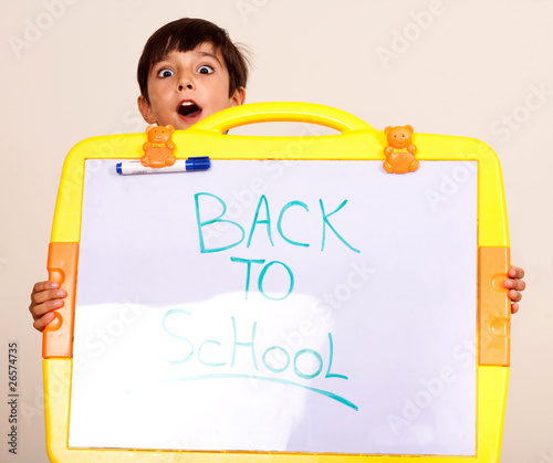 Little boy holding a whitebaord
