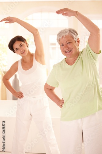 Elderly woman with personal fitness trainer