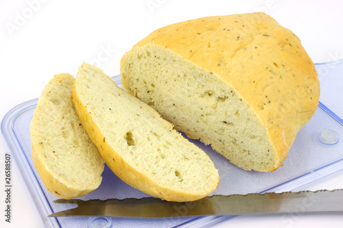 Focaccia bread loaf cut on blue cutting board