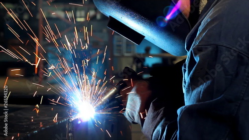 Welder at work in factory