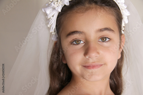 Close up of girl dressed for her first communion