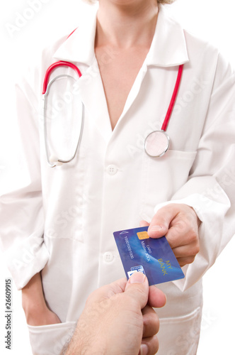 man's hand paying doctor with credit card