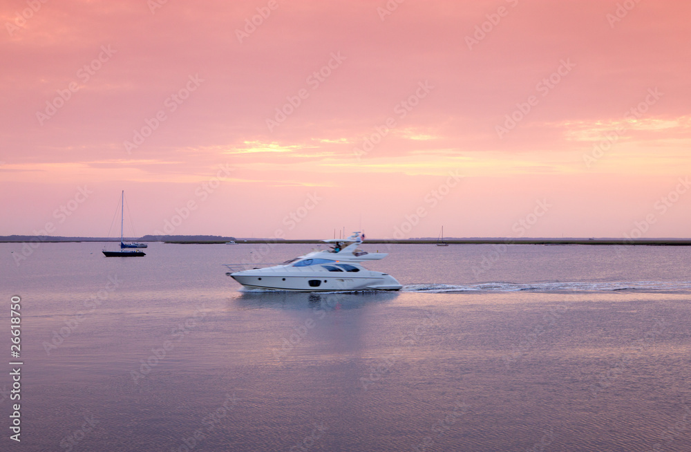Saiingl boat against sea sunset