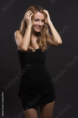 nice woman smiling in a dark studio © totti