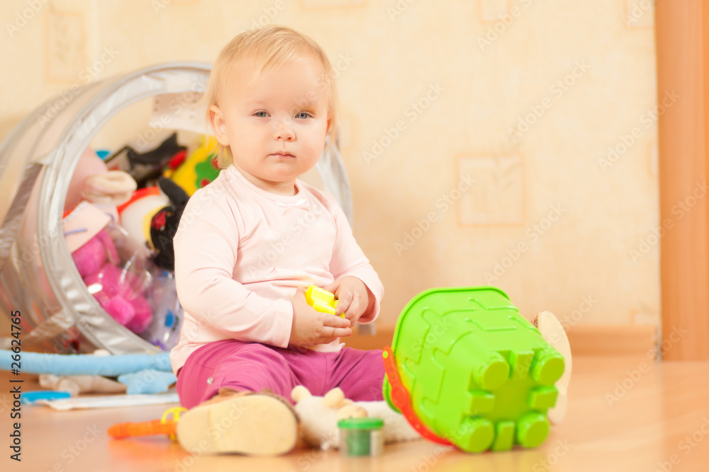 Adorable toddler girl play with bucket on floor Adorable toddler girl play with bucket on floor