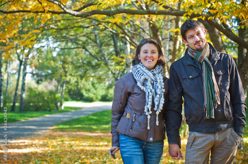 Romantic young beautiful couple on autumn walk