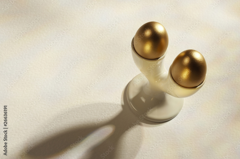 two gold eggs in double egg cup two gold eggs in double egg cup