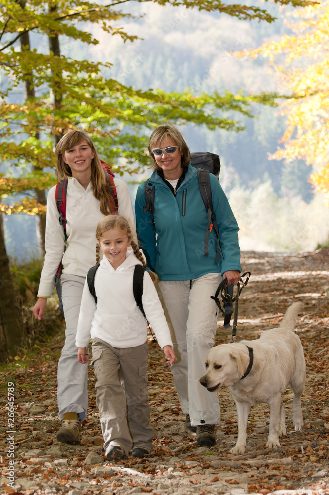 Obraz premium Family with dog on autumn trek
