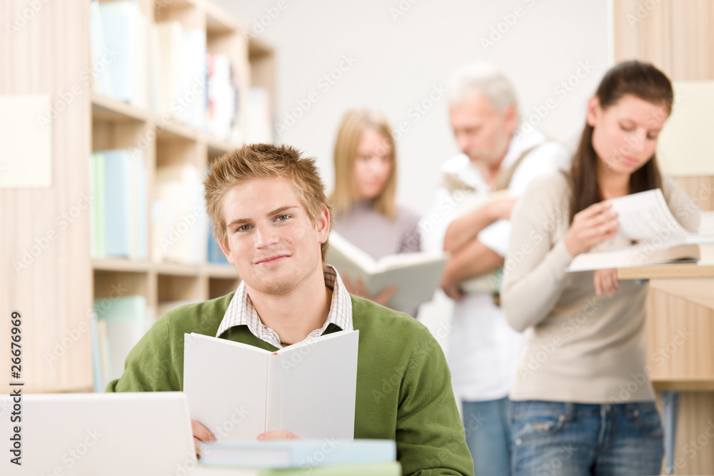 High school library - happy student with book High school library - happy student with book