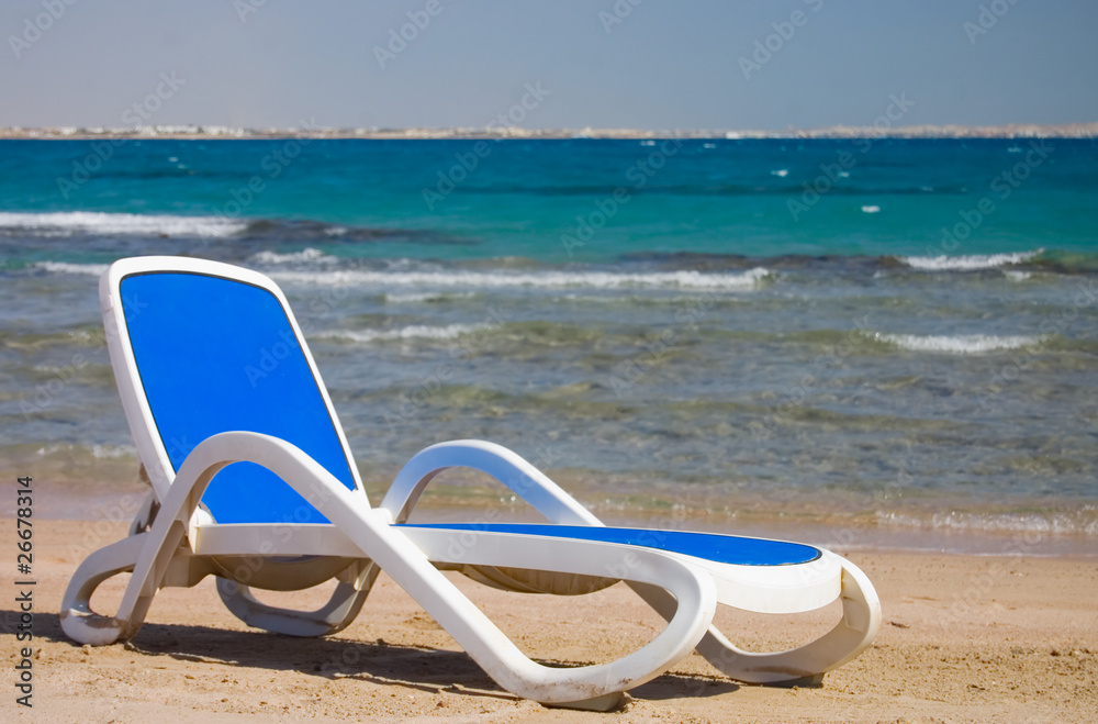 Dark blue chaise lounge at the sea Dark blue chaise lounge at the sea