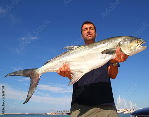 Fisherman holding catch Garrick Lichia Amia photo