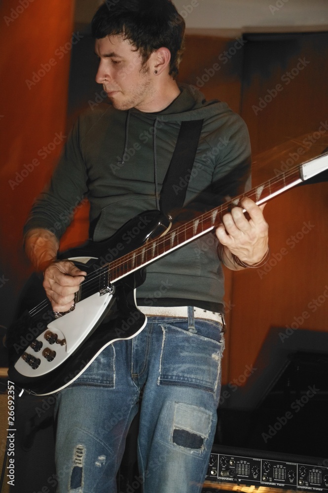 Obraz premium Man Plays His Electric Guitar