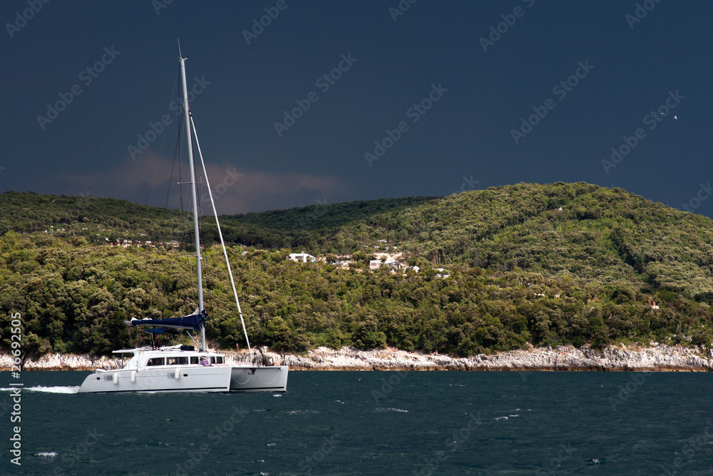 Catamaran at famous Limsky canal before thunderstorm. Catamaran at famous Limsky canal before thunderstorm.