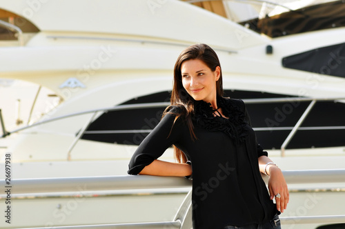 Happy beautiful woman in yacht club