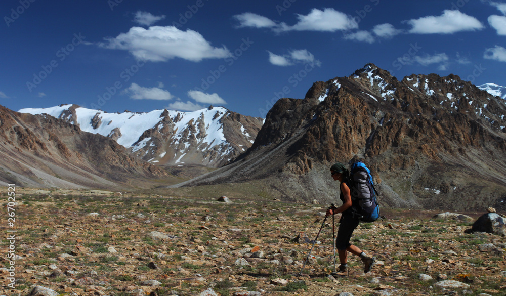 Hiker with backpack in mountains of Central Asia