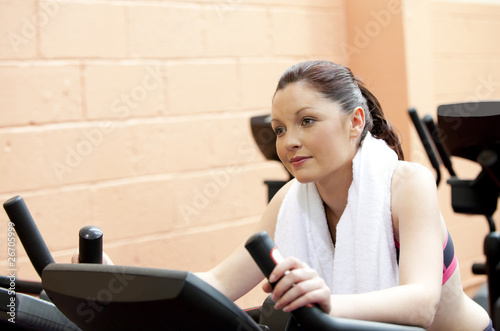 Beautiful woman training on a bicycle in a fitness center