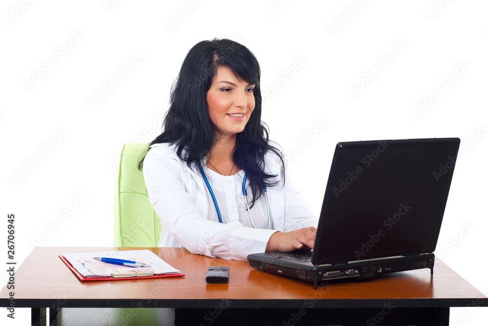 Cheerful doctor woman using laptop Cheerful doctor woman using laptop