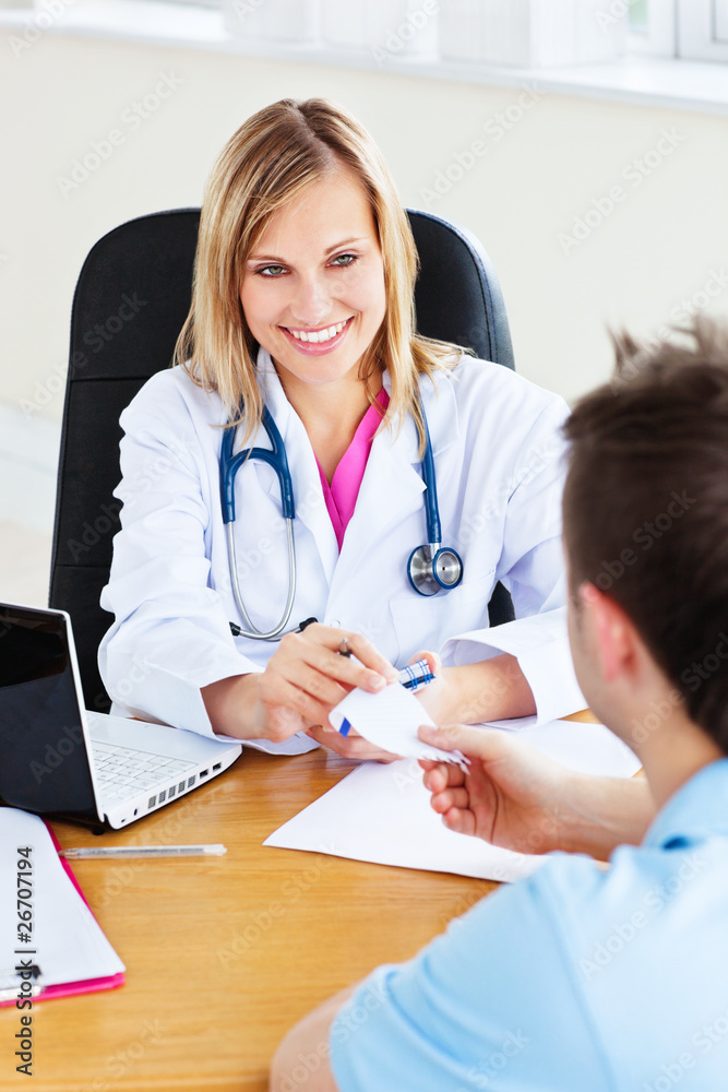 Beautiful doctor giving a prescription to her male patient Beautiful doctor giving a prescription to her male patient