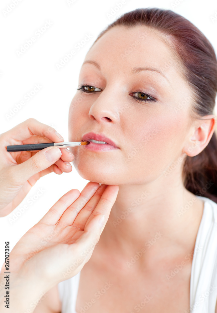 Close-up of a proud woman being made-up by a professional artist