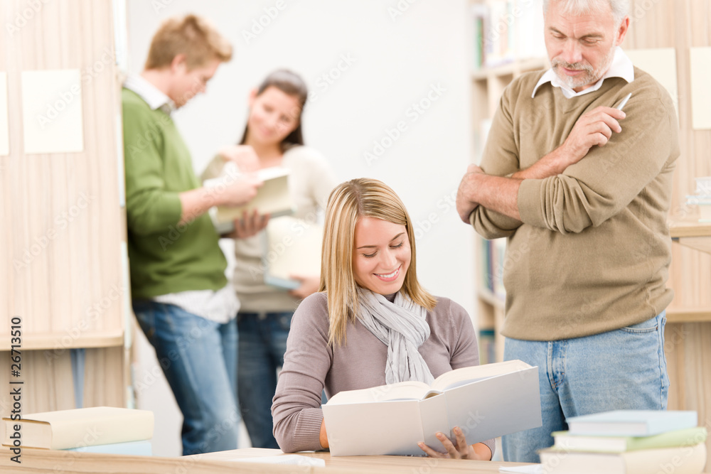 High school library - student with professor High school library - student with professor