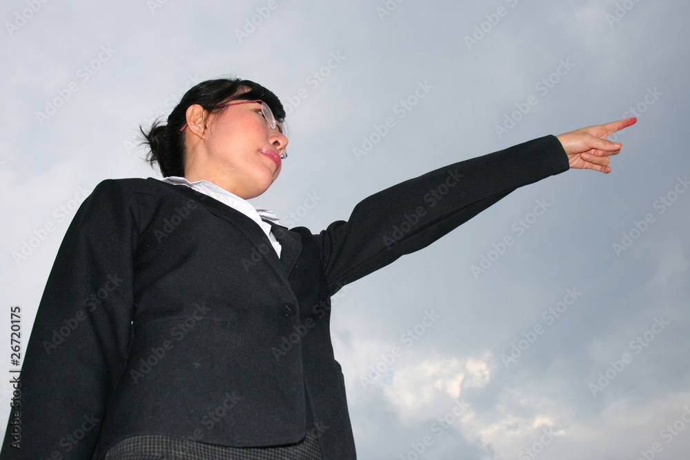 Asian business woman under a cloudy sky. Asian business woman under a cloudy sky.