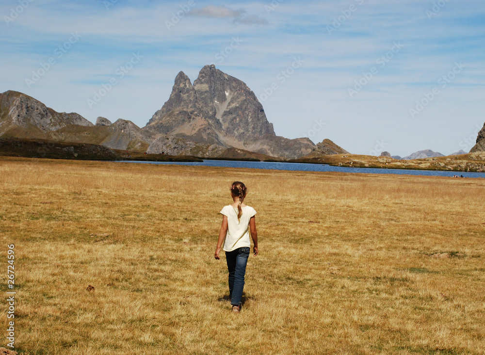 Small girl walking at Anayet plateau Small girl walking at Anayet plateau