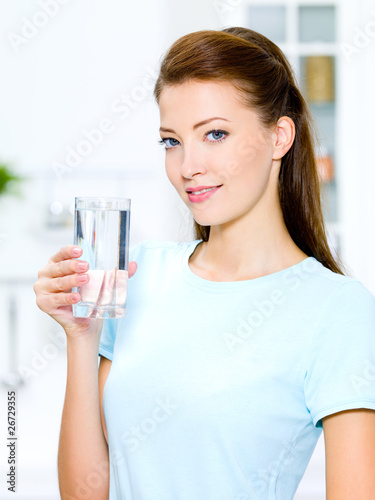 woman holds a glass with water