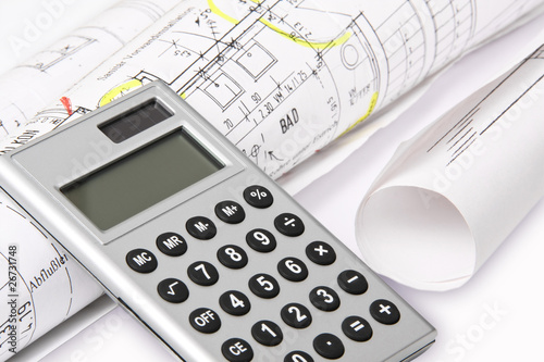 Calculator with architect`s plans photo