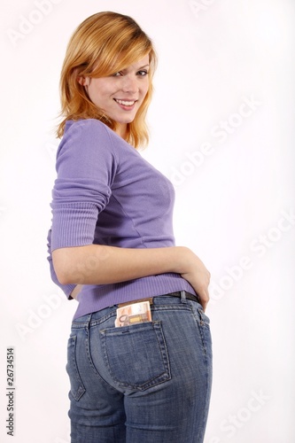 young woman with bank notes in jeans