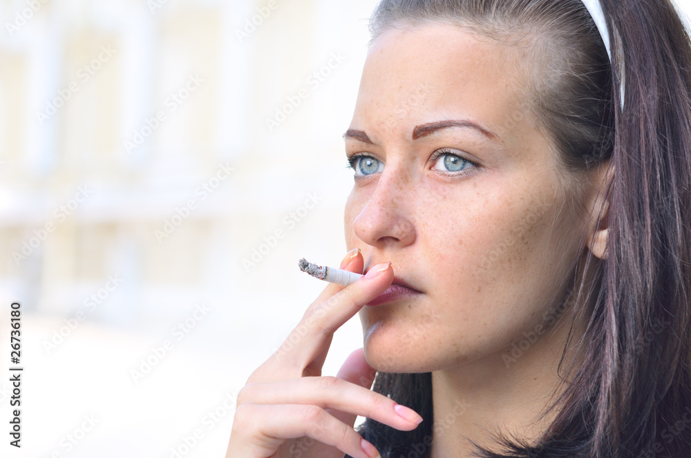 closeup of a pretty woman smoking at the street closeup of a pretty woman smoking at the street