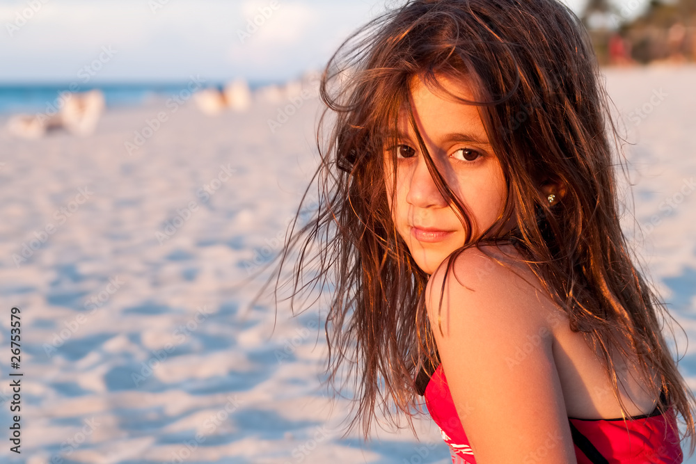 Beautiful girl with long hair lit by the sunset on a beach Stock Photo ...